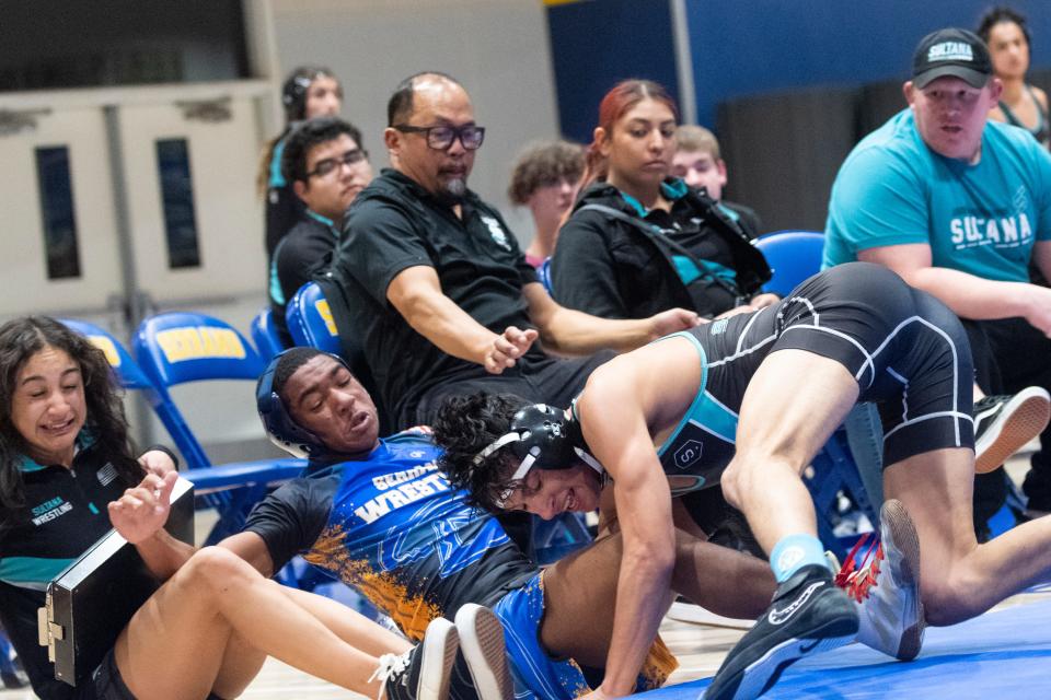 Sultana’s Andrew Diaz and Serrano’s Trevor McSween crash out of bounds during their 132-pound match in Phelan on Thursday, Jan. 13, 2022. Diaz won the match but the Diamondbacks won the dual meet 48-31.