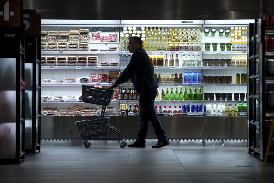 In this March 30, 2018, photo, a shopper pushes a cart as he walks through a 7FRESH grocery store operated by Chinese e-commerce retailer JD.com in Beijing, China. The Chinese e-commerce billionaire who faces a possible rape accusation in Minneapolis built his business by promising honesty in a market plagued by fraud and fakes. (AP Photo/Mark Schiefelbein)