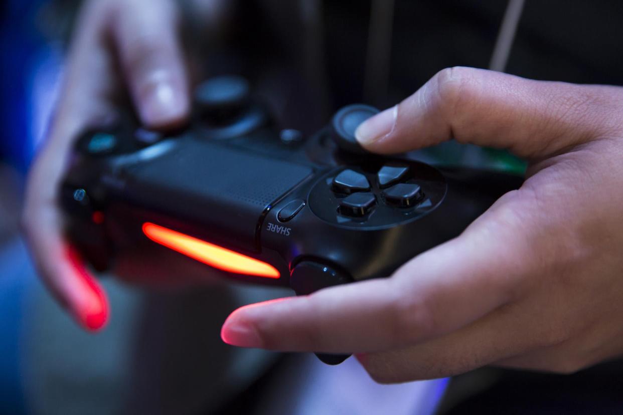 An attendee plays a video game on the PlayStation 4 video game console in the Sony Interactive Entertainment booth during the Tokyo Game Show 2018 on September 20, 2018 in Chiba, Japan: Tomohiro Ohsumi/Getty Images