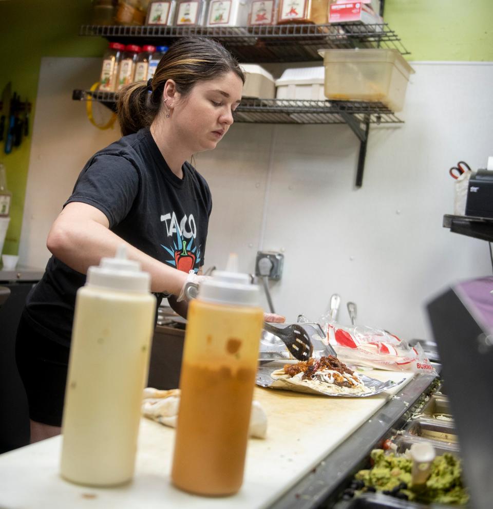Taco Tontos manager Emma Lasko works on a burrito order.
