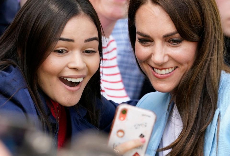 The Princess of Wales poses for selfie photograph as she meets members of the public on the Long Walk near Windsor Castle. (POOL/AFP via Getty Images)