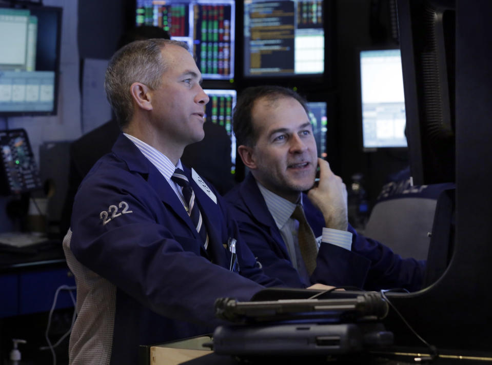 Traders work in their booth on the floor of the New York Stock Exchange Tuesday, Jan. 28, 2014. Stocks are higher in early trading on Wall Street as the stock market turns positive after three days of losses. (AP Photo/Richard Drew)