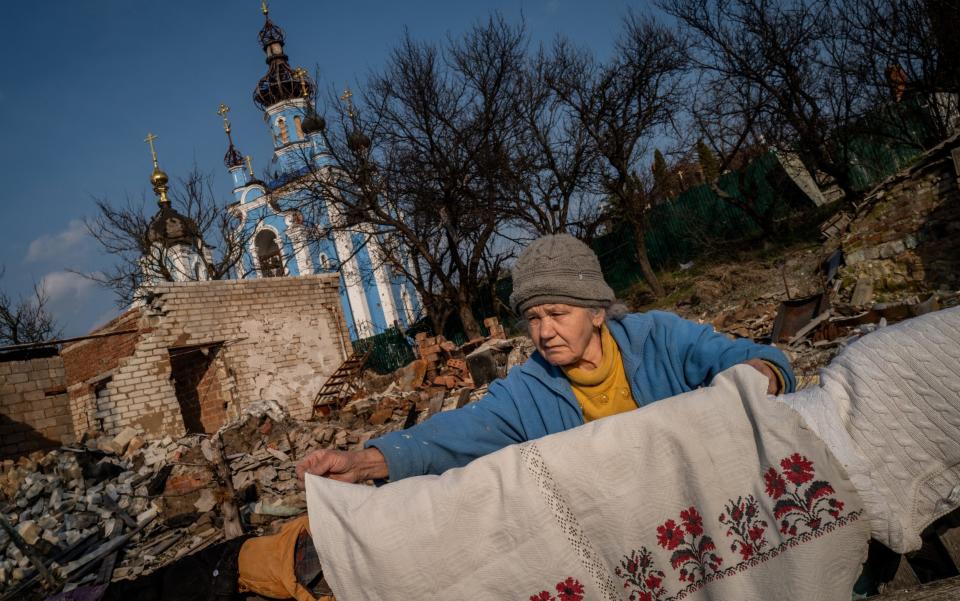 BOHORODYCHNE, UKRAINE - MARCH 24: 67 year-old Lyubov Yergorivna is seen in front of the her destroyed home as daily life continues under difficult conditions amid Russia-Ukraine war in the village of Bohorodychne of Donetsk Oblast, Ukraine on March 24, 2023. The village of Bohorodychne in the Donetsk Oblast of eastern Ukraine was one of the frontlines of the war in June and was under control of Russian forces in August until it was liberated by Ukrainian forces in September 2022. (Photo by Wolfgang Schwan/Anadolu Agency via Getty Images) - Wolfgang Schwan/Anadolu Agency via Getty Images