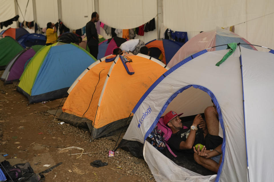 Venezuelan migrant Jorbys Ocampo rests inside a tent in a temporary camp after crossing the Darien Gap from Colombia in Lajas Blancas, Panama, Thursday, June 27, 2024. (AP Photo/Matias Delacroix)