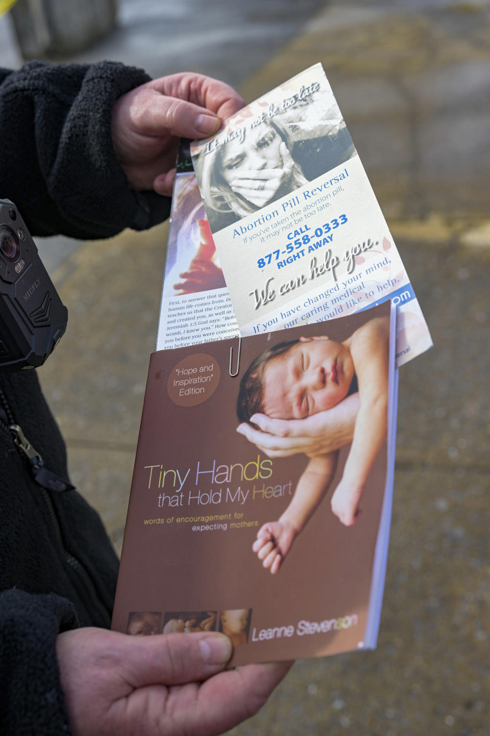 Debra Mehaffey shows the information she tries to hand out to women who go to the Bristol Women's Health Clinic in Bristol, Va. Residents in southwestern Virginia have battled for months over whether abortion clinics limited by strict laws in other states should be allowed to hop over the border and operate there. Similar scenarios are beginning to play out in communities along state lines around the country since the U.S. Supreme Court overturned Roe v. Wade. (AP Photo/Earl Neikirk)