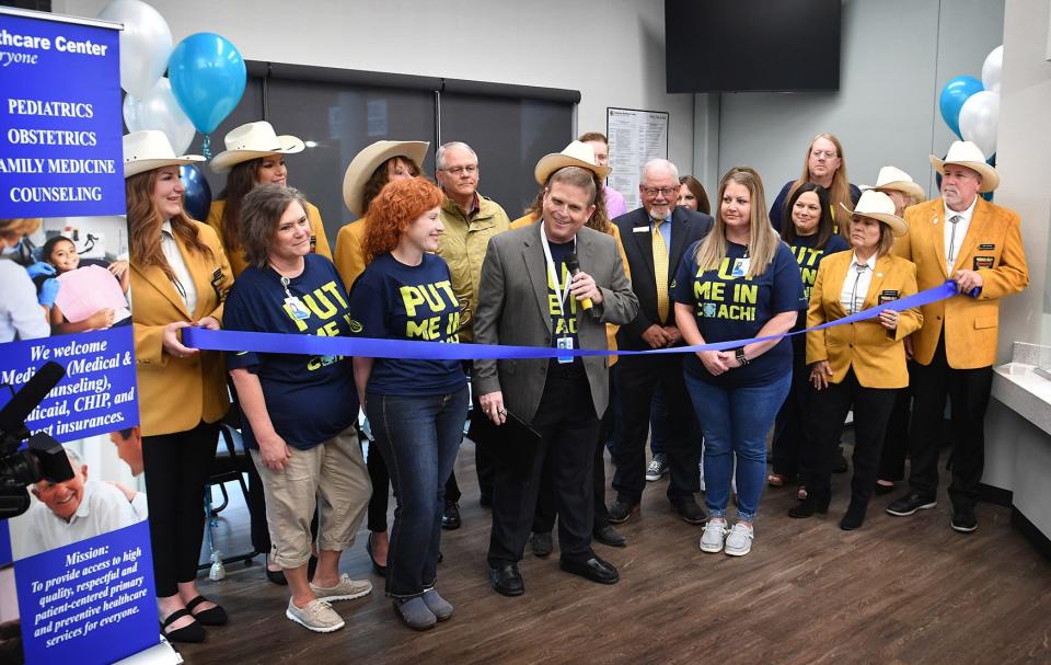 Community Healthcare Center CEO Allen Patterson and Vernon College President Dr. Dusty Johnston, center, prepare to cut the ribbon on the new clinic at Vernon College in Wichita Falls. The clinic has been open more than a year but pandemic restrictions prevented an earlier grand opening.