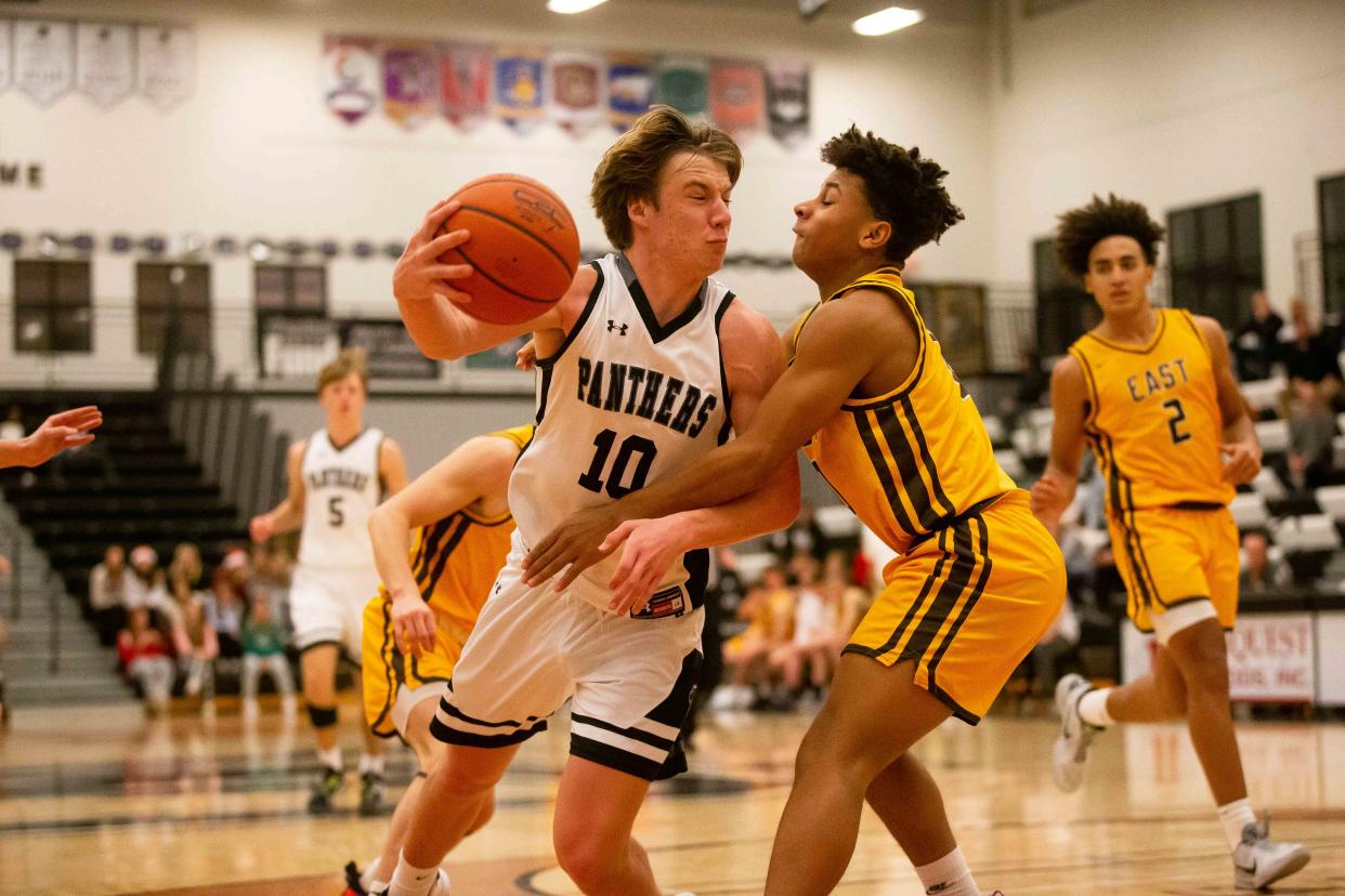 West Ottawa's Bryce Baldwin drives into his East defender during the thrid quarter Tuesday, Dec. 20, 2022, at West Ottawa High School. 