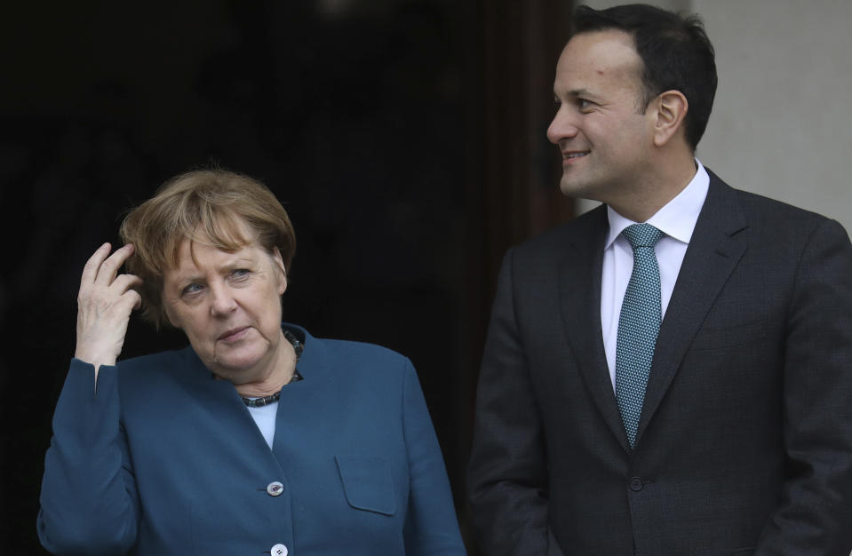 Irish Prime Minister Leo Varadkar looks at German Chancellor Angela Merkel as they pose at the entrance Farmleigh House for the media in Dublin, Ireland, Thursday, April 4, 2019. (AP Photo/Peter Morrison)