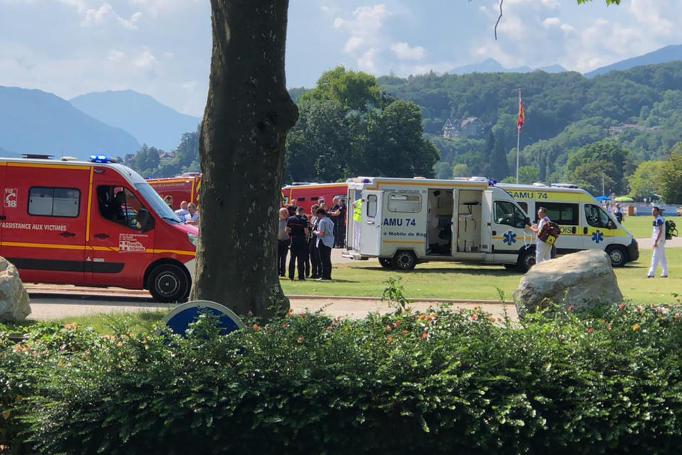 Ambulances and rescue trucks are seen after a knife attack in a park of Annecy, French Alps, Thursday, June 8, 2023. An attacker with a knife stabbed several young children and at least one adult, leaving some with life-threatening injuries, in a town in the Alps on Thursday before he was arrested, authorities said. (Florent Pecchio/L'Essor Savoyard via AP)