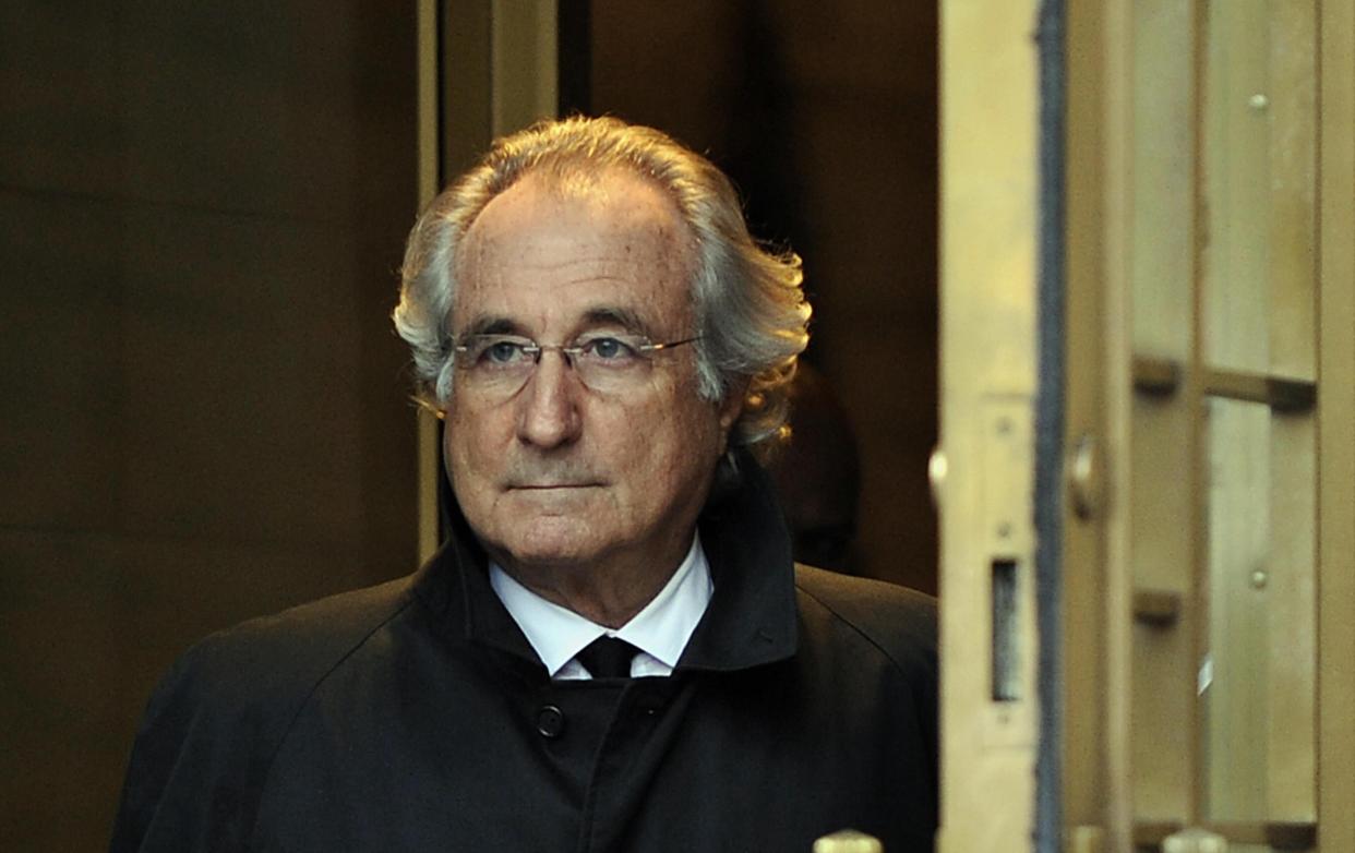 <p>Bernard Madoff leaves US Federal Court while being investigated for fraud in 2009</p> (AFP via Getty Images)