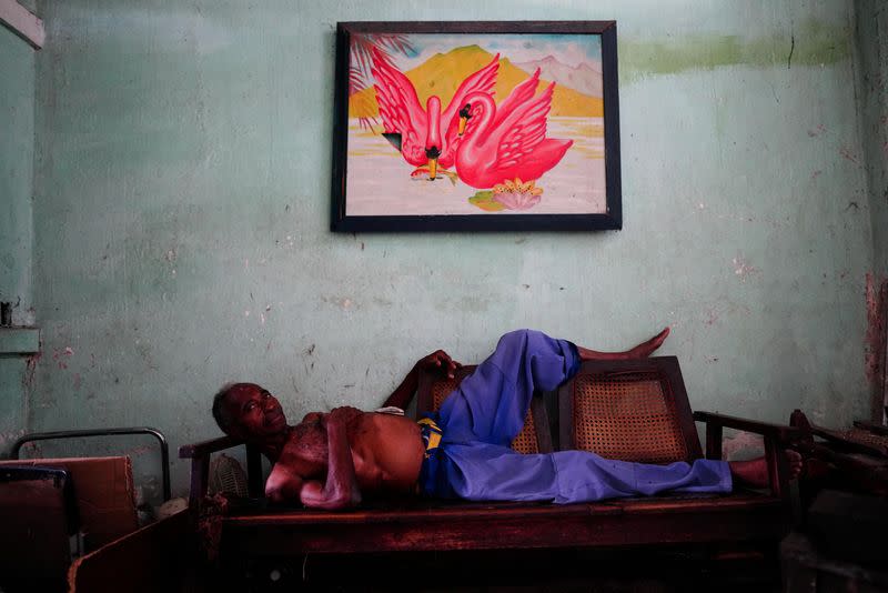 Retired mechanic Rafael Menzies tries to rest at home during a blackout, in Santiago