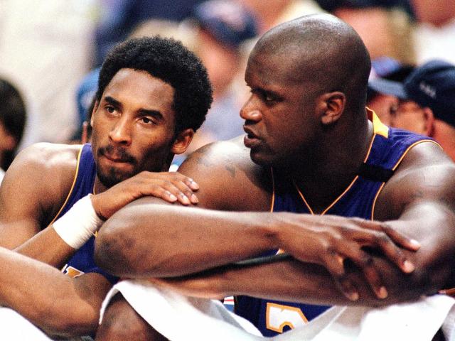 Los Angeles Lakers Kobe Bryant, left, holding the championship trophy,  celebrates with teammates Rick Fox, Lindsey Hunter, second from right, and  Shaquille O'Neal, right, holding the MVP trophy, after winning Game 4