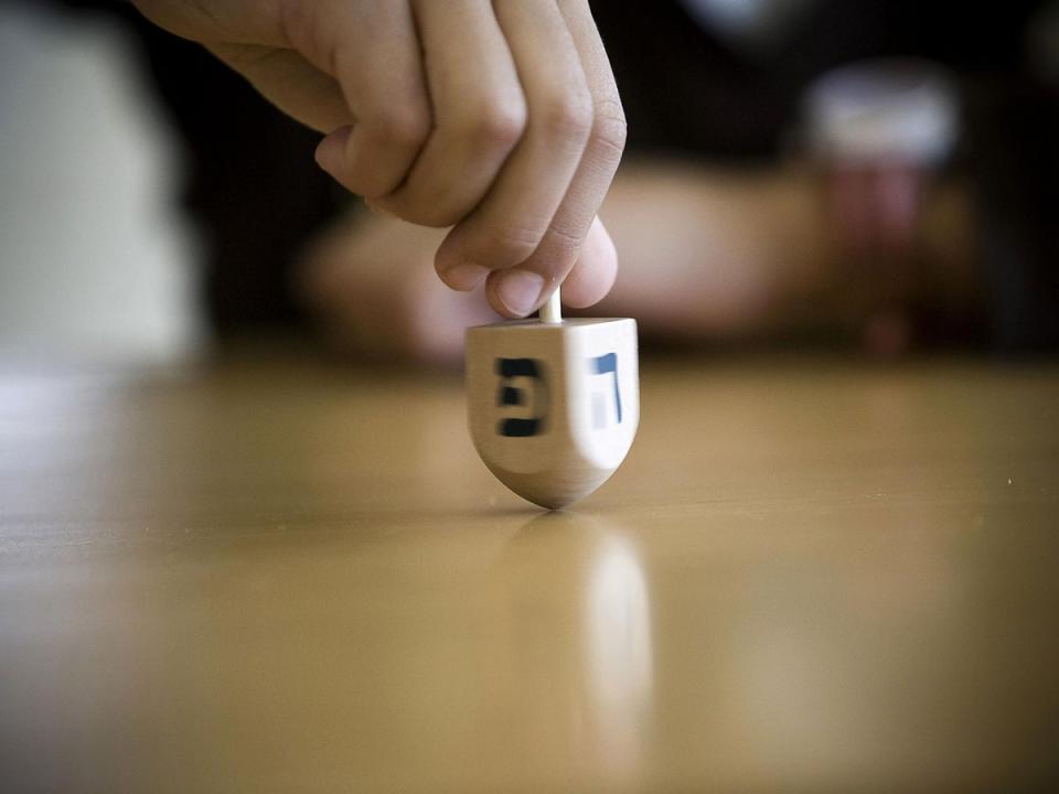 A Dreidel is spun as part of a competition during the Jewish festival of Hanukkah Getty (Getty)