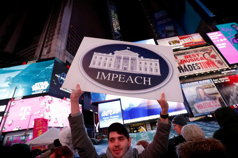 Demonstrators gather to demand the impeachment and removal of U.S. President Donald Trump during a rally at Times Square in New York City