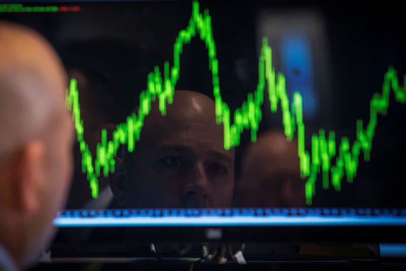 FILE PHOTO: FILE PHOTO: A Specialist trader watches his chart while working on the floor of the New York Stock Exchange