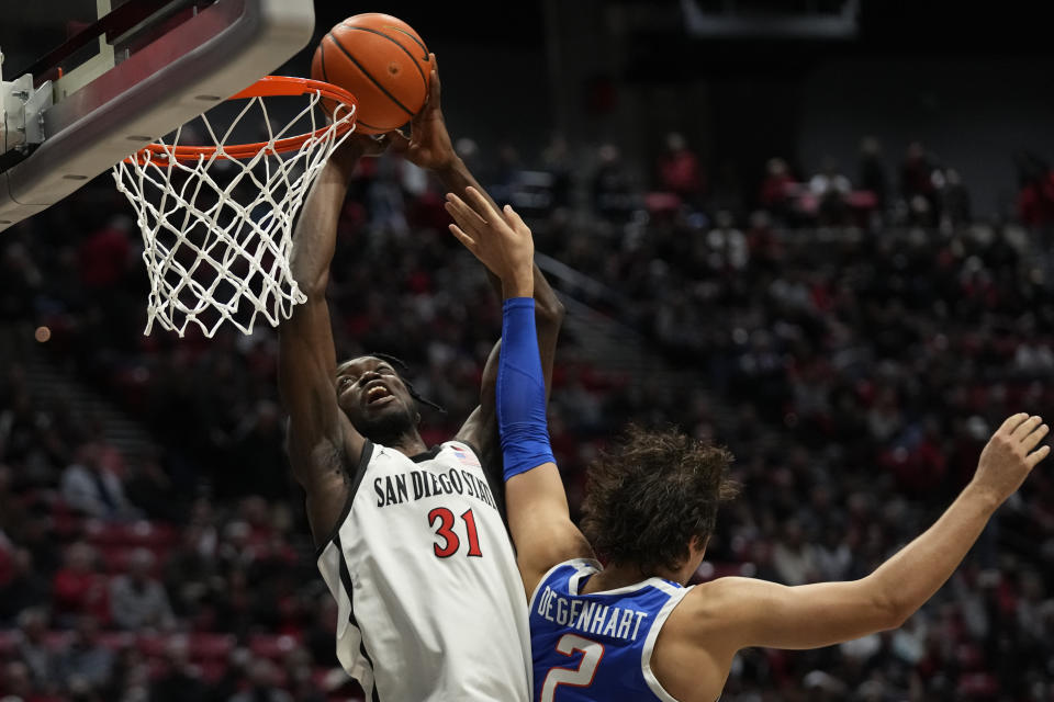 San Diego State forward Nathan Mensah (31) shoots as Boise State forward Tyson Degenhart defends during the first half of an NCAA college basketball game Friday, Feb. 3, 2023, in San Diego. (AP Photo/Gregory Bull)