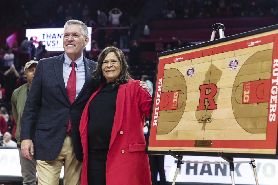 Director of Athletics at Rutgers University, Pat Hobbs, left, with former Rutgers head coach, C. Vivian Stringer, at a ceremony held in her honor during half time at the Big Ten Conference women's college basketball game between the Rutgers Scarlet Knights and the Ohio State Buckeyes in Piscataway, N.J., Sunday, Dec. 4, 2022. (AP Photo/Stefan Jeremiah)