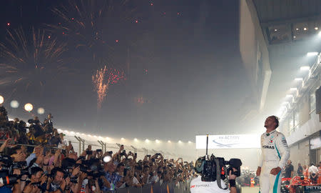 Motor Racing - Formula One - F1 Singapore Grand Prix 2018 - Singapore - September 16, 2018 Mercedes' Lewis Hamilton celebrates after winning the race REUTERS/Kim Hong-Ji
