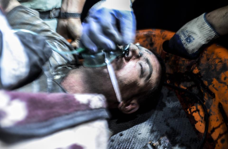 An injured miner came out carried by rescuers after an explosion in Manisa on May 13, 2014.(BULENT KILIC/AFP/Getty Images)