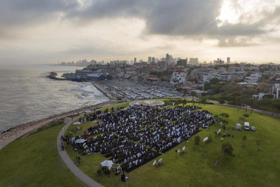 Muslim worshippers offer Eid al-Adha prayer in the mixed Arab Jewish city of Jaffa, near Tel Aviv, Israel, Wednesday, June 28, 2023. Muslims celebrate the holiday to mark the willingness of the Prophet Ibrahim (Abraham to Christians and Jews) to sacrifice his son. During the holiday, they slaughter sheep or cattle, distribute part of the meat to the poor and eat the rest. (AP Photo/Oded Balilty)