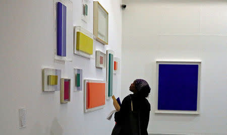 A visitor looks at works by French artist Yves Klein on display as part of the launch of the winter season at the Tate gallery in Liverpool, northern England October 20, 2016. REUTERS/Phil Noble