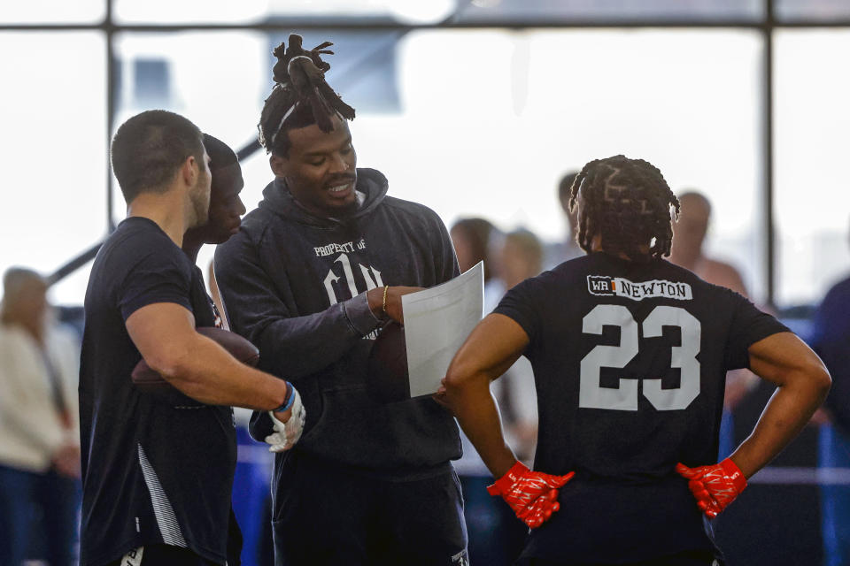 Former NFL and Auburn quarterback, Cam Newton, talks with receivers during Auburn Pro Day, Tuesday, March 21, 2023, in Auburn, Ala. (AP Photo/Butch Dill)