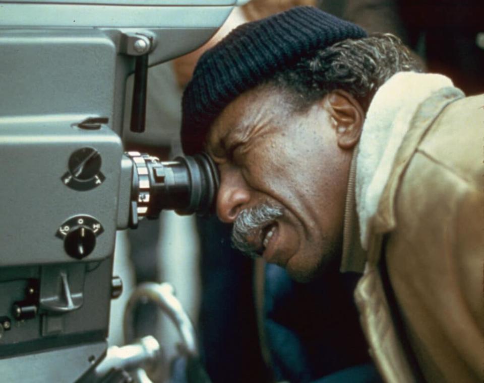 American film director and photographer Gordon Parks looks through the viewfinder of a camera on the set of a film, circa 1971. (Photo by Hulton Archive/Getty Images)