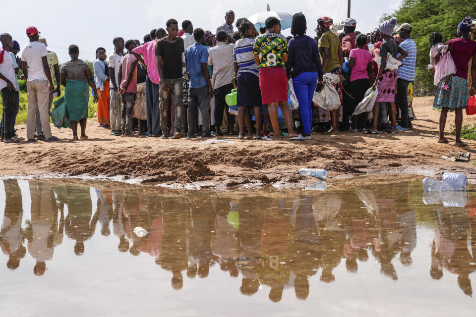 FILE - Residents gather for a planned distribution of food, after El Niño rains damaged their houses in Bangale town in Tana River county, Kenya, Nov. 26, 2023. Ongoing catastrophic rains in Eastern Africa have been worsened by human-caused climate change that made them up to two times more intense, an international team of climate scientists said Thursday, Dec. 7. (AP Photo/Brian Inganga, file)