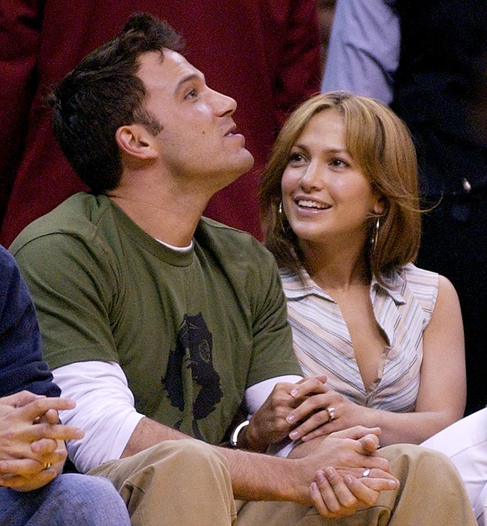 Ben Affleck and Jennifer Lopez sit together during Game 4 of the Western Conference Semifinals between the Los Angeles Lakers and the San Antonio Spurs, May 11, 2003, in Los Angeles. The couple split in 2004, but almost 17 years later rumors of their reunion have started to trend on social media.