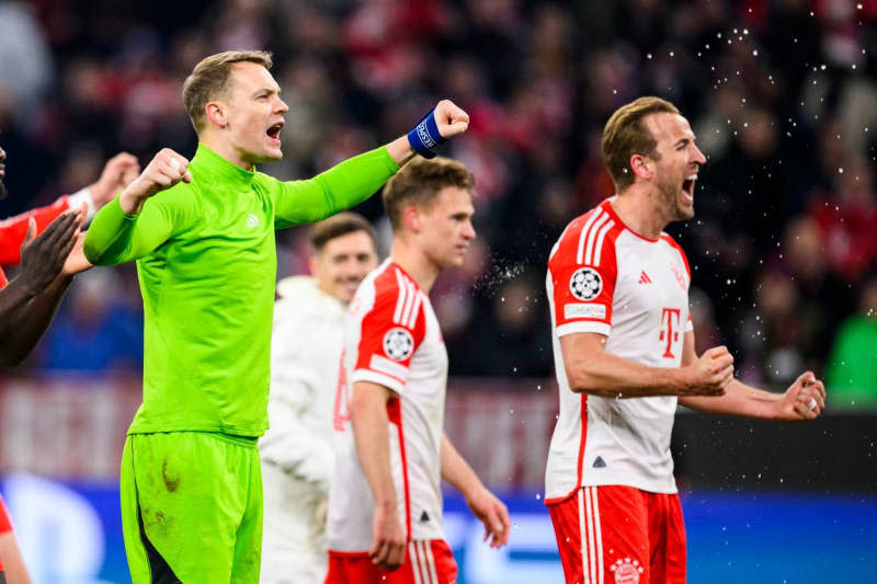 Munich goalkeeper Manuel Neuer (L) and Munich's Harry Kane (R) celebrate following the UEFA Champions League quarter-final second leg soccer match between Bayern Munich and FC Arsenal at Allianz Arena. Tom Weller/dpa