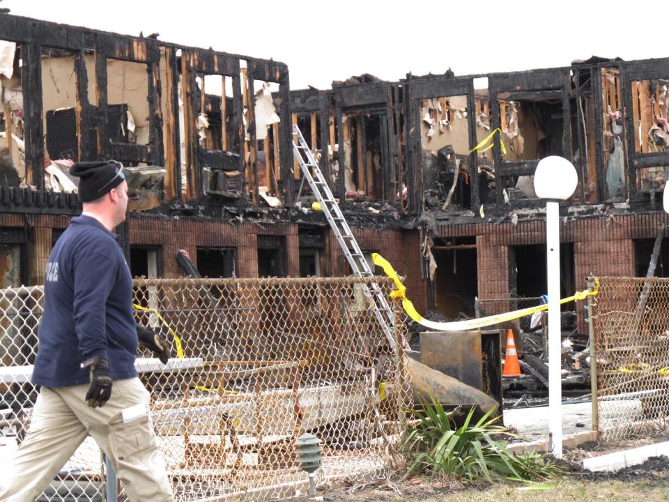 Investigators go through the rubble of a motel in Point Pleasant Beach N.J., on Saturday, March 22, 2014. Autopsies were being conducted Saturday on the four people who died in a fire at a Jersey shore motel that housed some victims who lost their homes when Superstorm Sandy hit. Al Della Fave, a spokesman for the Ocean County Prosecutor's Office, said the medical examiner's office is trying to identify the victims and determine how they died in the blaze at the Mariner's Cove Motor Inn in Point Pleasant Beach early Friday morning. An intense investigation into the cause of the blaze began Friday afternoon after the last of the four bodies was removed. Eight people were injured in the fire. The probe into the cause is expected to take several days. (AP Photo/Wayne Parry)