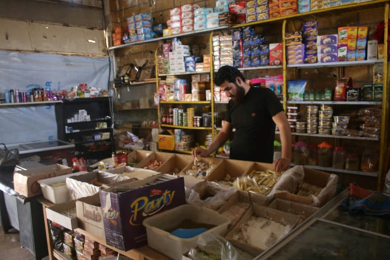 A Syrian man stands in his shop in a rebel-held area in the southern Syrian city of Daraa
