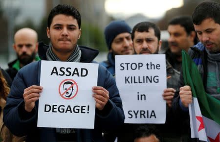 People demonstrate against the Syrian regime ahead of the start of the Syrian Peace talks outside the U.N. European headquarters in Geneva, Switzerland, January 29, 2016. Banner reads : "Assad go away". REUTERS/Denis Balibouse