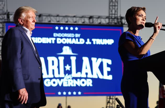 Former US president Donald Trump looks on as Arizona Republican nominee for governor Kari Lake speaks during a campaign rally in Mesa. (Photo: Mario Tama via Getty Images)