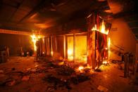 A subway ticket office is seen on fire during a protest against the increase in the subway ticket prices in Santiago