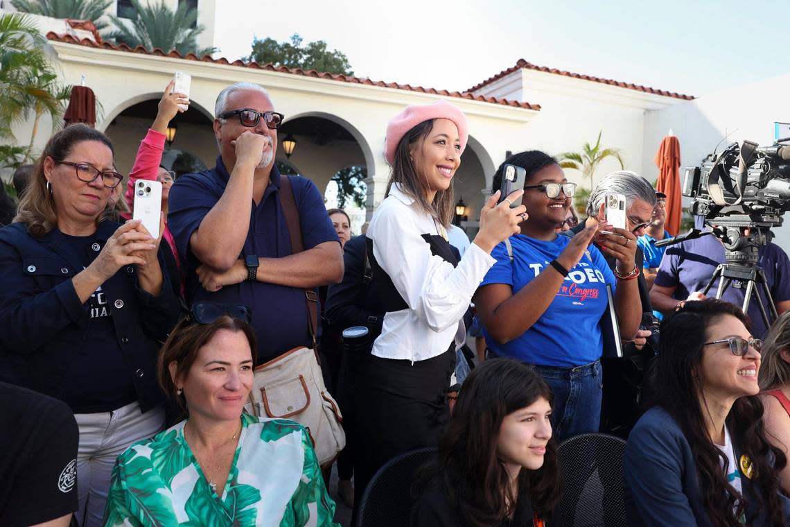 Heidy Torr, center, pink hat, and Mel de Miami, right, smile during a Latino Victory Fund’s Get Out The Vote Rally on Thursday, Oct. 20, 2022, at Books & Books in Coral Gables.