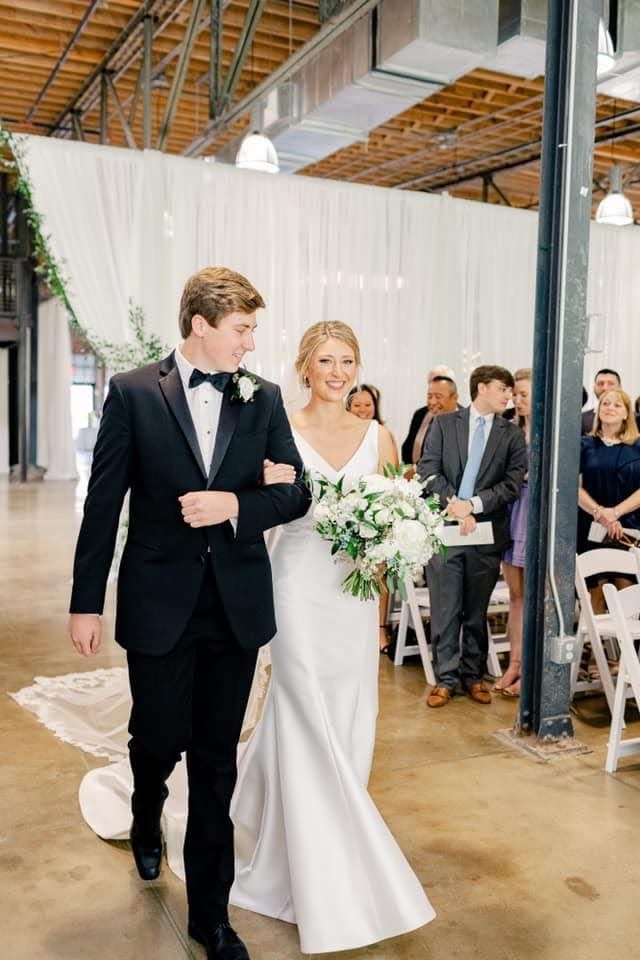 Will Reichard walks his sister, Taylor Cathers, down the aisle at her wedding in May 2021.
