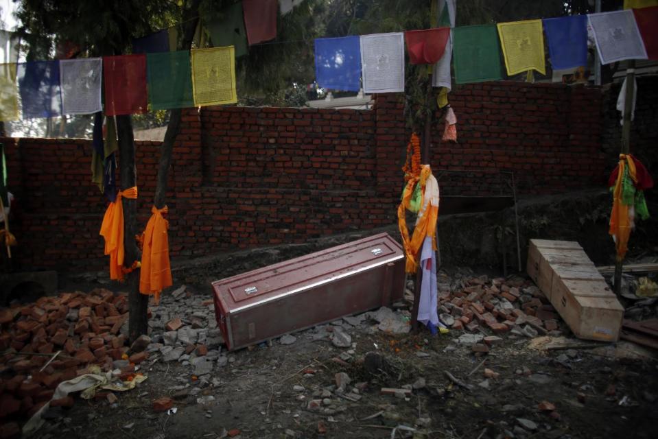 In this Monday, Nov. 29, 2016 photo, a red coffin that brought home the body of Nepali migrant worker from Saudi Arabia, lies on the ground empty after cremation rituals were completed at Swayambhunath stupa in Kathmandu, Nepal. The number of Nepali workers going abroad has more than doubled since the country began promoting foreign labor in recent years: from about 220,000 in 2008 to about 500,000 in 2015. Yet the number of deaths among those workers has risen much faster in the same period. In total, over 5,000 workers from this small country have died working abroad since 2008, more than the number of U.S. troops killed in the Iraq War. (AP Photo/Niranjan Shrestha)