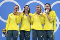 Australia's women's 4x100m women's relay team, Meg Harris, Bronte Campbell, Emma McKeon and Cate Campbell celebrate on the podium at the 2020 Summer Olympics, Sunday, July 25, 2021, in Tokyo, Japan. (AP Photo/Matthias Schrader)