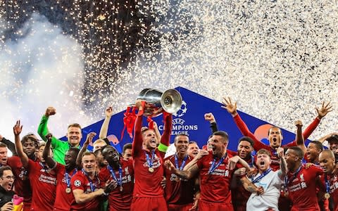 Liverpool's Jordan Henderson lifts the trophy with his team-mates after winning the UEFA Champions League Final at the Wanda Metropolitano - Credit: PA