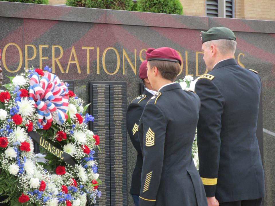 Command Sgt. Maj. JoAnn Naumann and Lt. Gen. Jonathan Braga, the senior enlisted leader and commander of the U.S. Army Special Operations Command,  render a salute at the command's memorial wreath during a ceremony Thursday, May 25, 2023, at Fort Bragg.