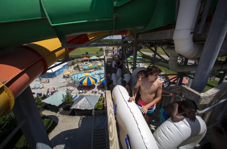 Visitors carry inner tubes up the Sea Tubes slides at Zoombezi Bay water park in Powell on Friday, June 19, 2020. Delayed due to coronavirus concerns, Friday was the first day the park was open to season pass holders and zoo gold members for the 2020 summer season.