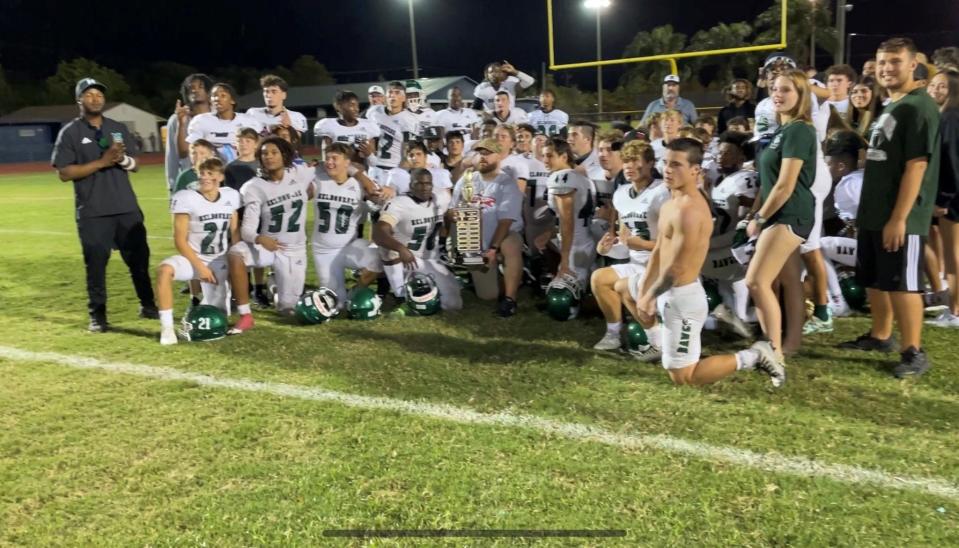 Melbourne High football players and coaches celebrate their win over Eau Gallie on Nov. 4, 2022.