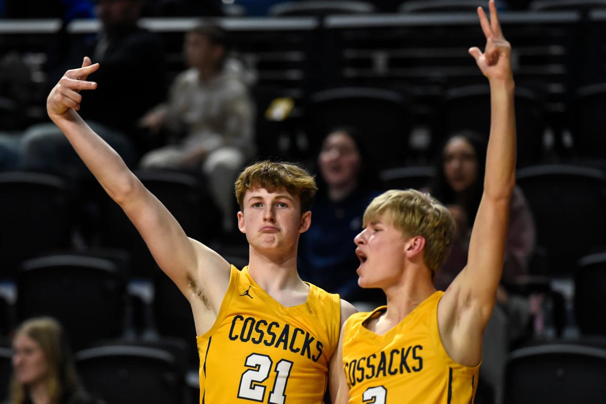 Sioux Valley's Tobin Squires (21) and Bret Milton (3) celebrate a 3-point basket during their consolation semifinal game in the state Class A boys basketball tournament on Friday, March 15, 2024 in the Summit Arena at The Monument in Rapid City. Sioux Valley won 67-58.