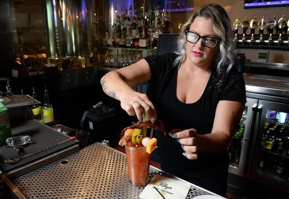 Bartender Jean Jacobsen prepares a bloody Mary at Riley’s Brew Pub in Clovis in this Fresno Bee file photo. The drink includes a garnish of bacon, a chicken wing, olive, cheese cube, onion and pepperoncini.