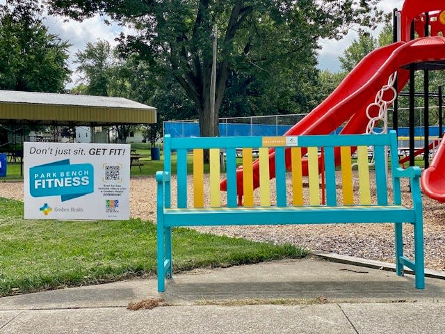 Signs have popped up next to park benches like this one, with a QR code leading to fitness videos, in an effort by Goshen Health.