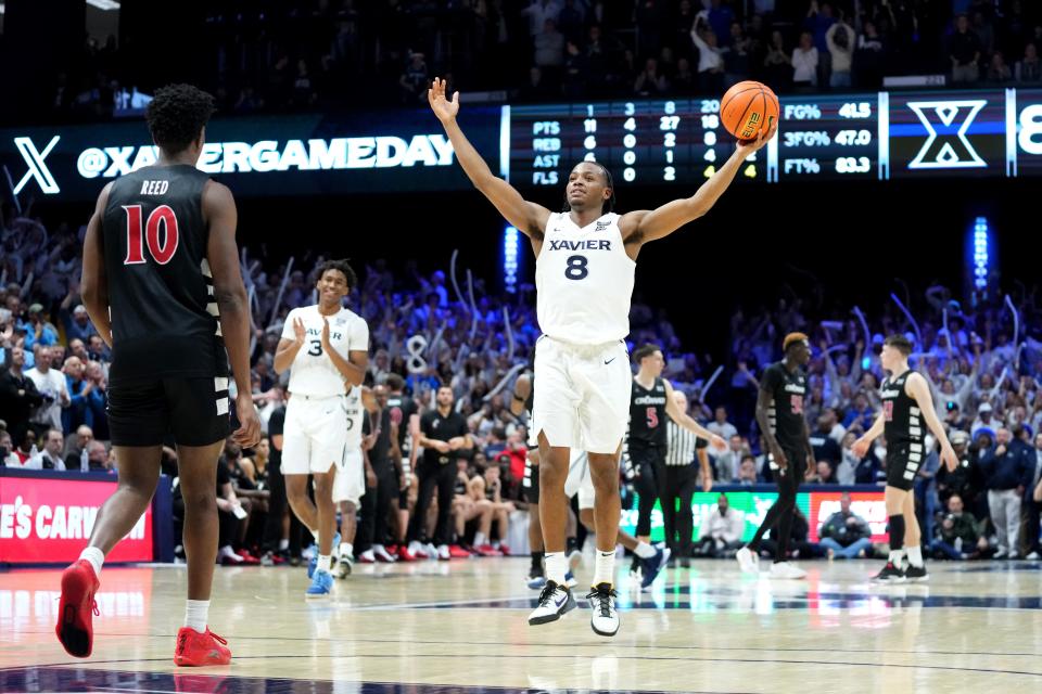 Xavier Musketeers guard Quincy Olivari celebrates the win at the conclusion of the91st Crosstown Shootout basketball game against the Cincinnati Bearcats on Dec. 9, 2023.