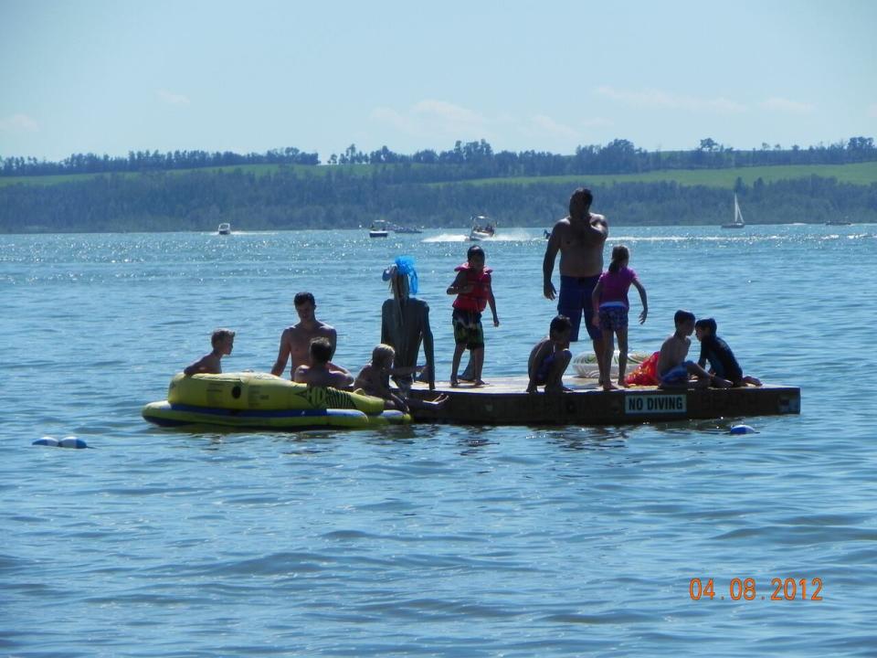 A family enjoying the waters of Gull Lake off Meridian Beach. 