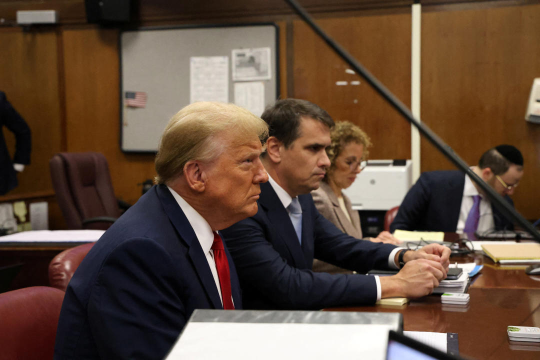 Donald Trump sits with with his lawyers in Manhattan criminal court.