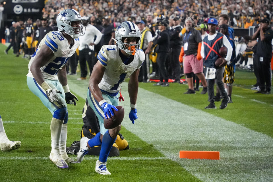 Dallas Cowboys wide receiver Jalen Tolbert (1) celebrates his touchdown catch with running back Rico Dowdle (23) during the second half of an NFL football game against the Pittsburgh Steelers, early Monday, Oct. 7, 2024, in Pittsburgh. The Cowboys won 20-17. (AP Photo/Gene J. Puskar)